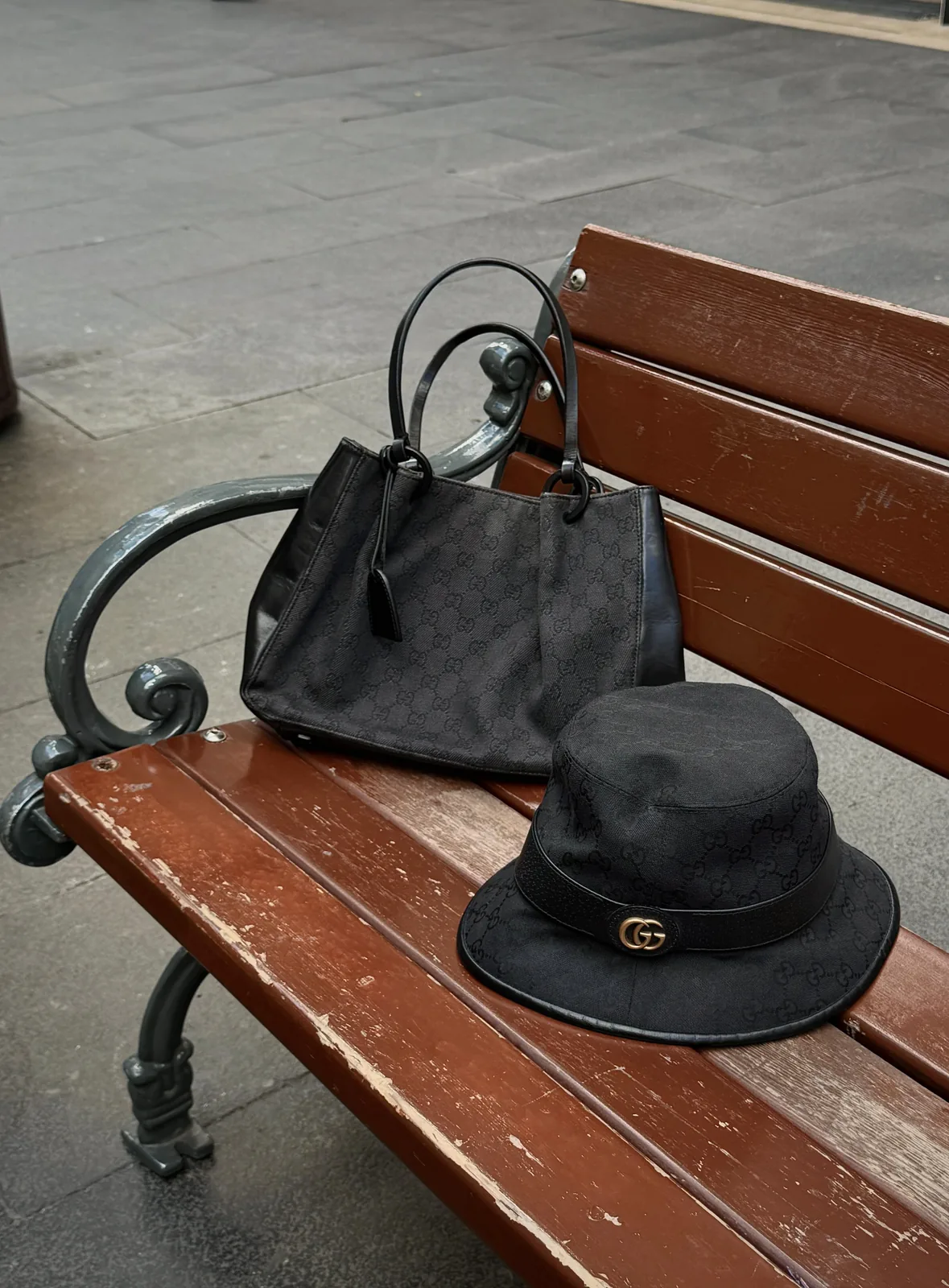 Curated luxury bag and accessories on a bench